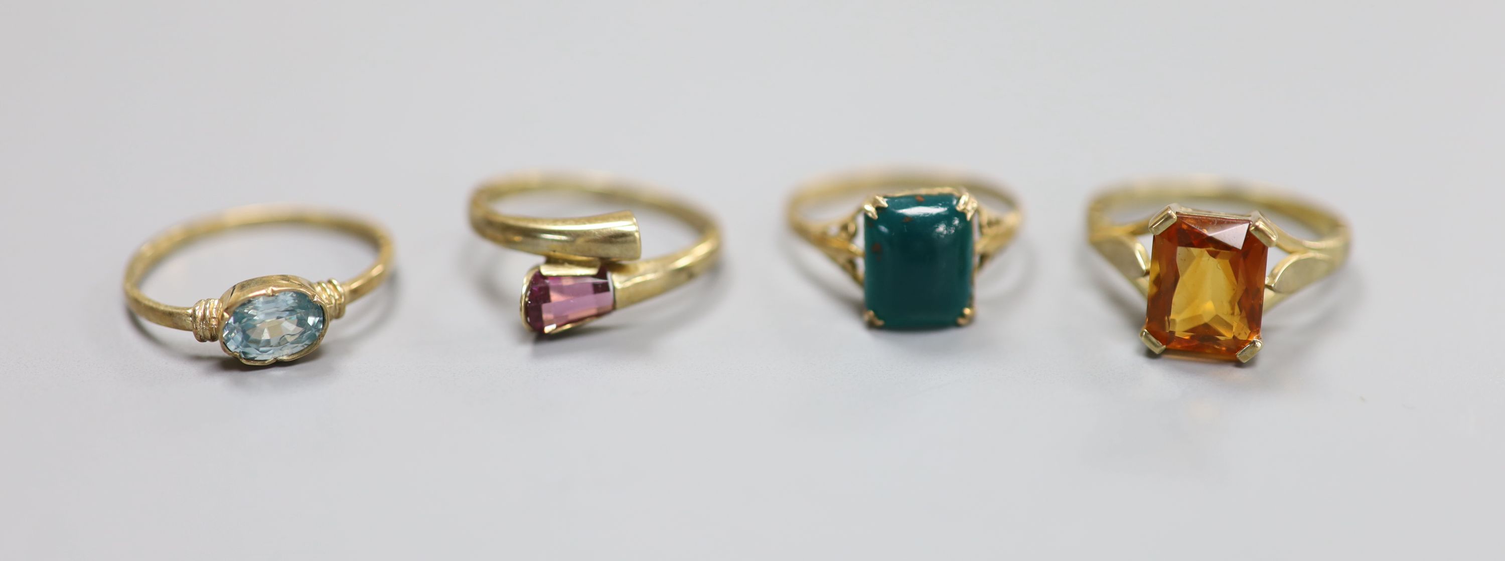 Five assorted modern 9ct gold and gem set dress rings, including bloodstone, garnet and blue zircon